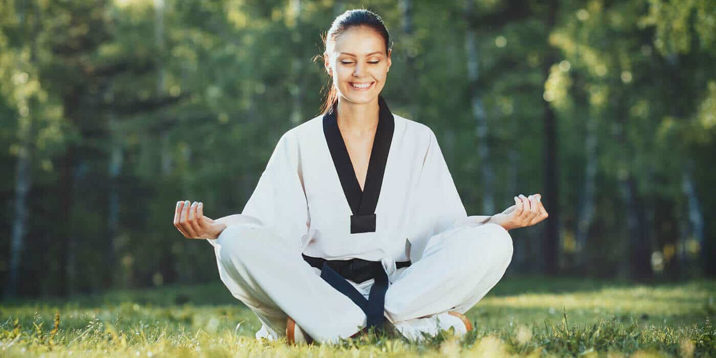 Martial Arts Lessons for Adults in Apex NC - Happy Woman Meditated Sitting Background